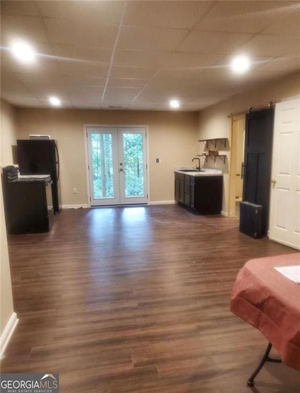 living room featuring french doors, baseboards, and dark wood-style flooring