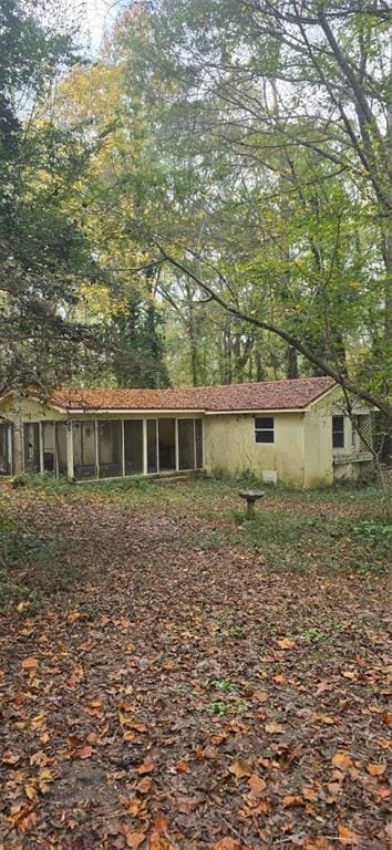 view of side of property featuring a sunroom