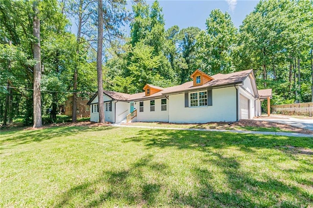 single story home with a front yard, driveway, and an attached garage