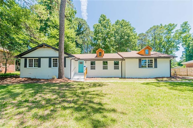 view of front of house featuring a front yard and fence