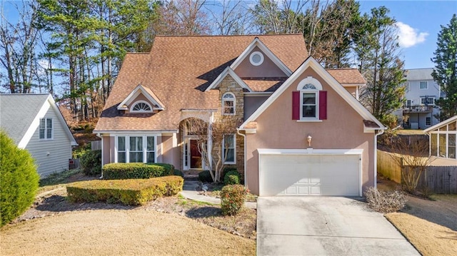 view of front of property with a garage and central AC