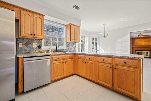 kitchen featuring light stone countertops, appliances with stainless steel finishes, and tasteful backsplash