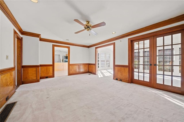 interior space featuring ceiling fan, crown molding, and french doors