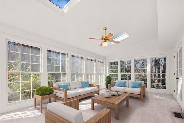 sunroom / solarium featuring vaulted ceiling with skylight and ceiling fan