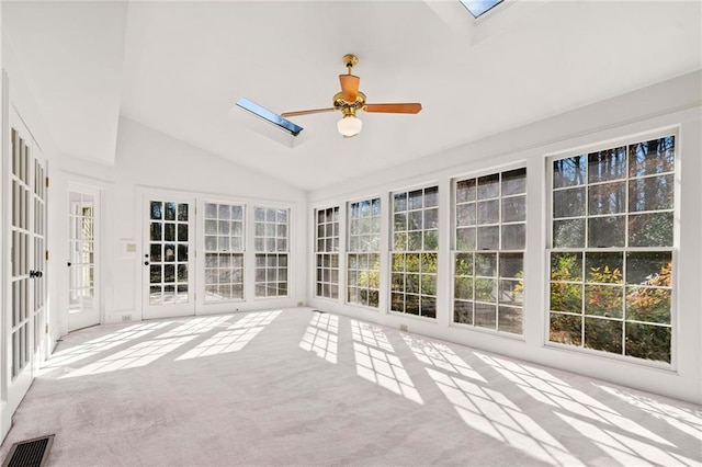 unfurnished sunroom with vaulted ceiling with skylight and ceiling fan