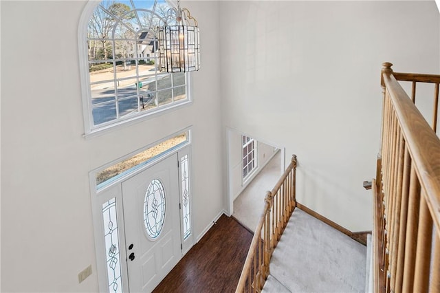 entryway with wood-type flooring and a notable chandelier