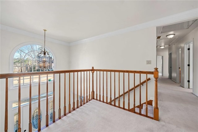 hallway with light carpet, ornamental molding, and a notable chandelier