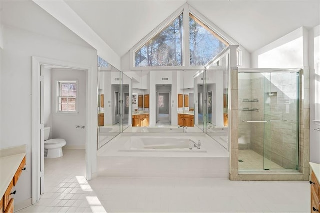 full bathroom with tile patterned floors, vanity, vaulted ceiling, shower with separate bathtub, and toilet