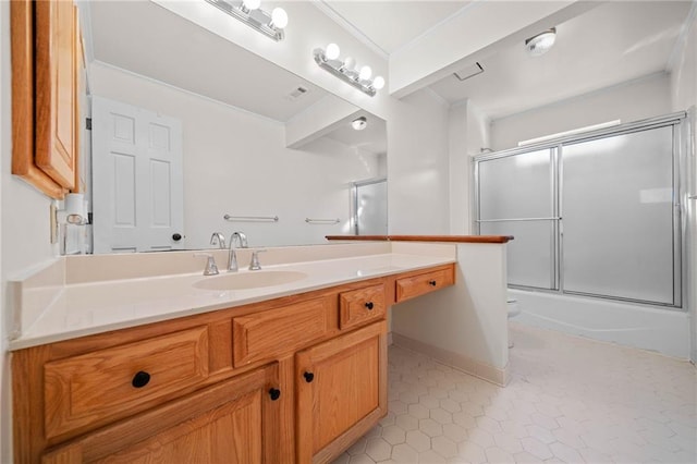 full bathroom featuring tile patterned flooring, vanity, enclosed tub / shower combo, and toilet