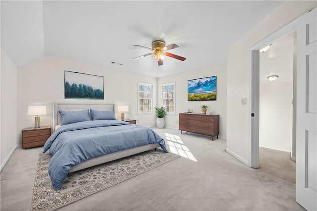 bedroom featuring ceiling fan, light carpet, and vaulted ceiling