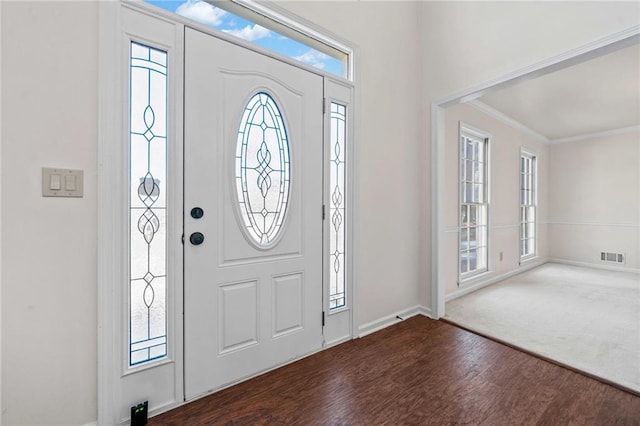 foyer featuring dark wood-type flooring and crown molding