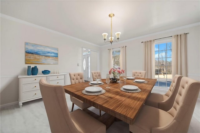 dining space featuring ornamental molding and a chandelier