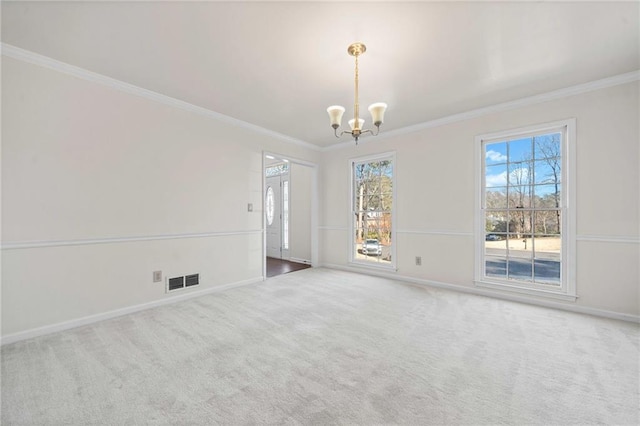 carpeted empty room with crown molding and an inviting chandelier