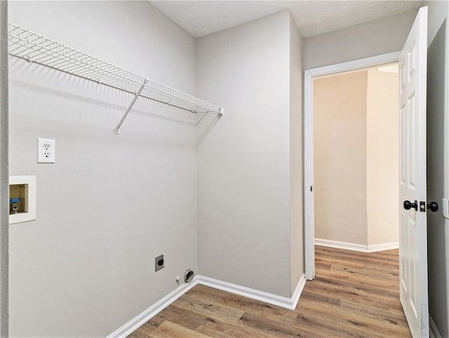 laundry room with washer hookup, electric dryer hookup, wood finished floors, laundry area, and baseboards