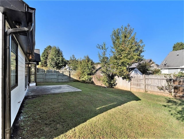 view of yard with a fenced backyard and a patio