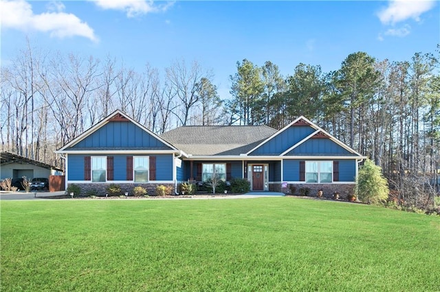 craftsman-style home featuring board and batten siding, a front yard, and stone siding