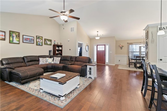 living room featuring visible vents, baseboards, a ceiling fan, dark wood-style flooring, and high vaulted ceiling