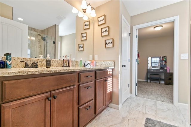 full bathroom with visible vents, a shower stall, baseboards, and double vanity