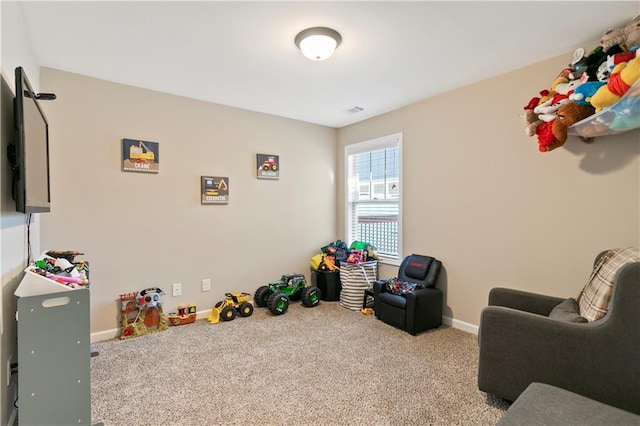 rec room with carpet floors and baseboards