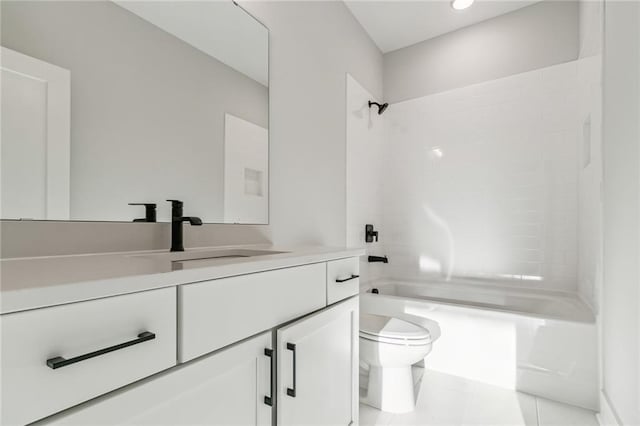 full bathroom featuring tile patterned floors, tiled shower / bath combo, toilet, and vanity