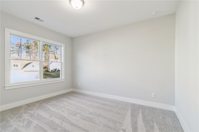 unfurnished room with light colored carpet