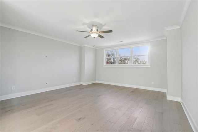 spare room with ceiling fan, ornamental molding, and light wood-type flooring