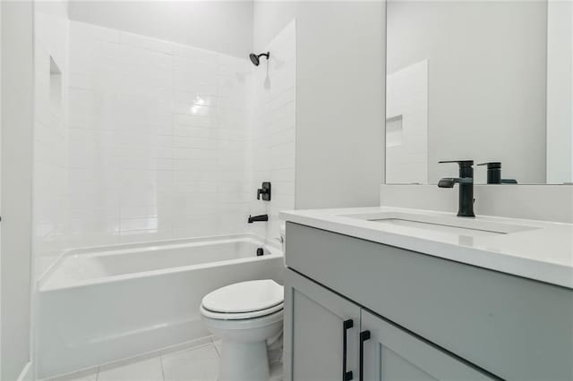 full bathroom featuring tile patterned floors, tiled shower / bath combo, toilet, and vanity