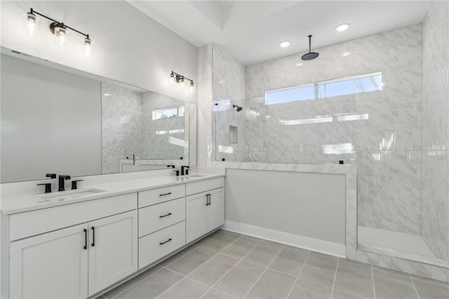 bathroom with tile patterned floors, vanity, and tiled shower