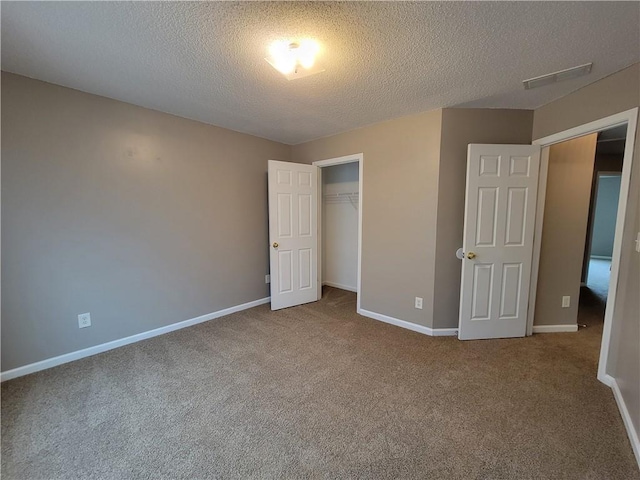 285 Fieldview Ln, Covington, GA 30016 - unfurnished bedroom featuring carpet, a textured ceiling, and a closet