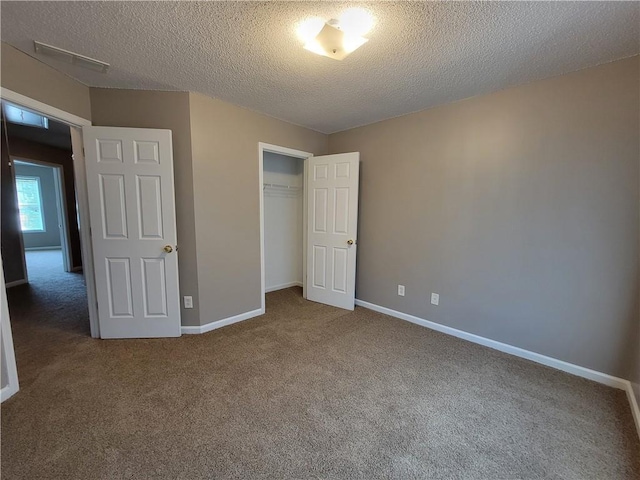 285 Fieldview Ln, Covington, GA 30016 - unfurnished bedroom featuring carpet flooring, a textured ceiling, and a closet