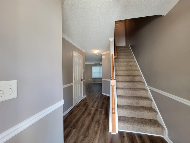 285 Fieldview Ln, Covington, GA 30016 - staircase featuring wood finished floors, a textured ceiling, and crown molding