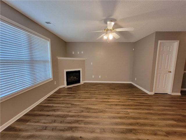 285 Fieldview Ln, Covington, GA 30016 - unfurnished living room featuring ceiling fan, dark wood-style floors, and a fireplace