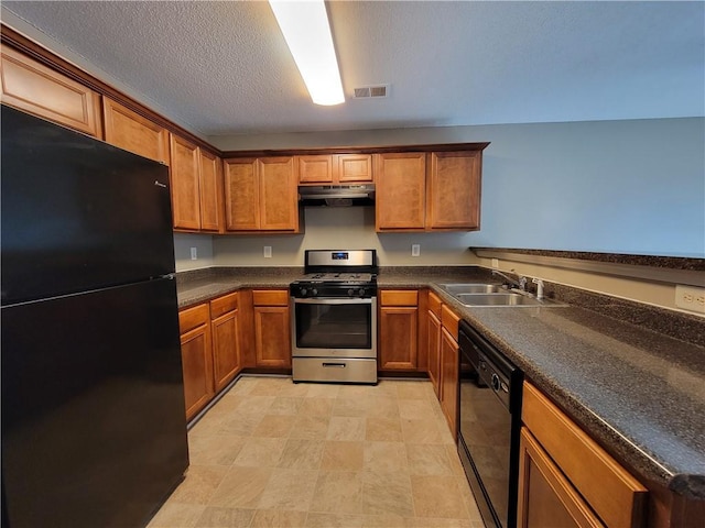 285 Fieldview Ln, Covington, GA 30016 - kitchen with black appliances, under cabinet range hood, brown cabinetry, dark countertops, and a textured ceiling