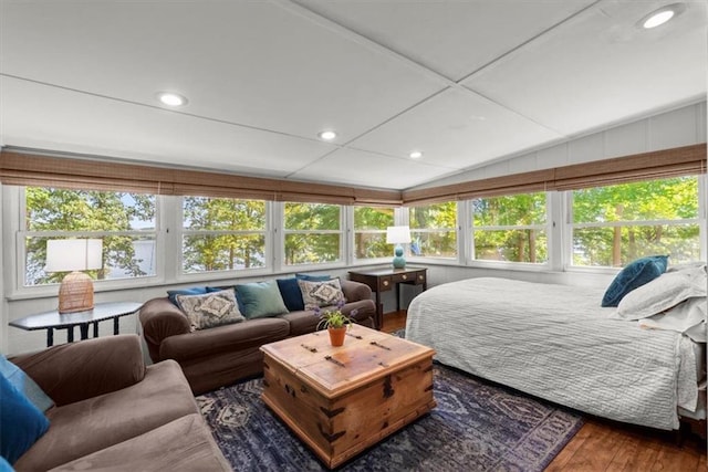 sunroom featuring vaulted ceiling and a healthy amount of sunlight