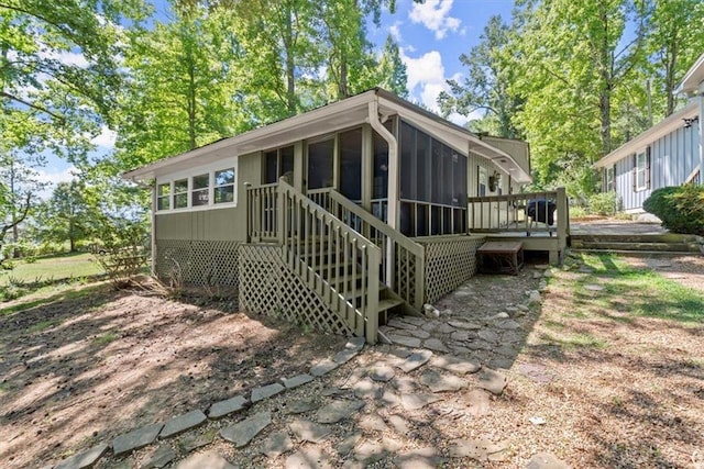 rear view of house with a sunroom