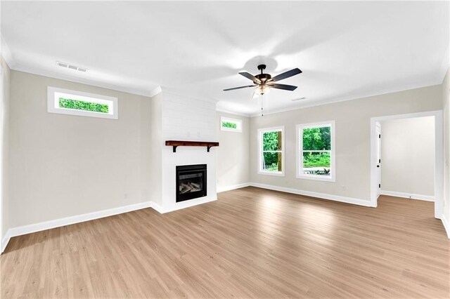 unfurnished living room featuring ceiling fan, light hardwood / wood-style floors, and ornamental molding