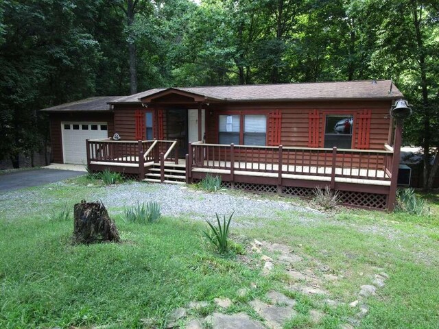 log-style house with a deck and a front yard