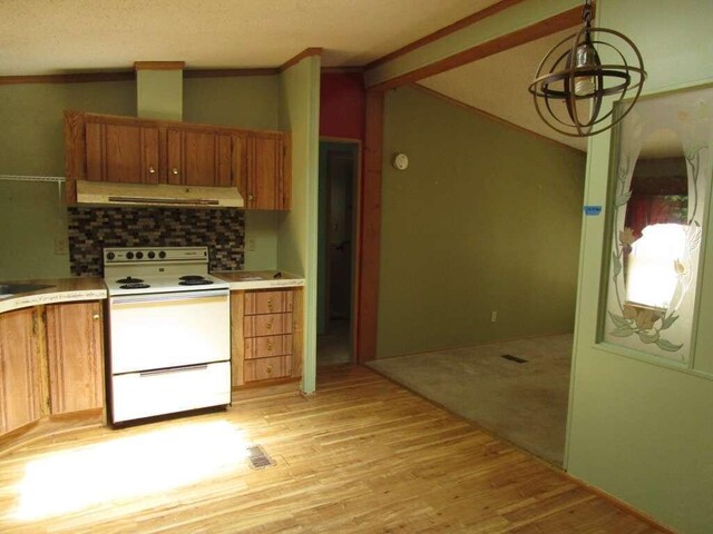 kitchen with tasteful backsplash, white electric range, light wood-type flooring, exhaust hood, and vaulted ceiling