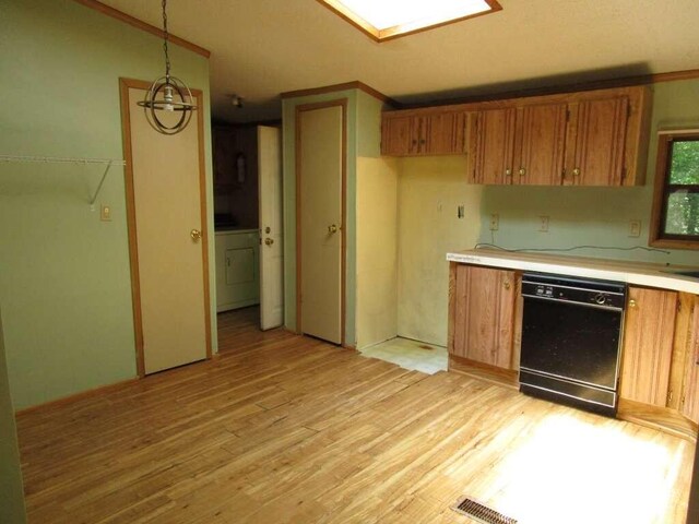 kitchen featuring dishwasher, crown molding, light wood-type flooring, and pendant lighting