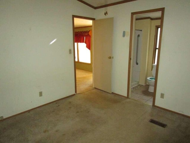 tiled spare room with lofted ceiling and crown molding