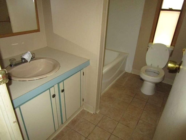 bathroom with vanity, toilet, and tile patterned floors