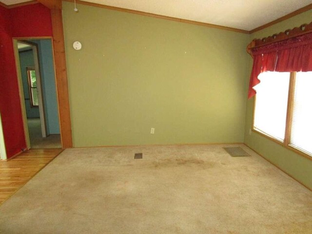 empty room featuring crown molding and hardwood / wood-style floors