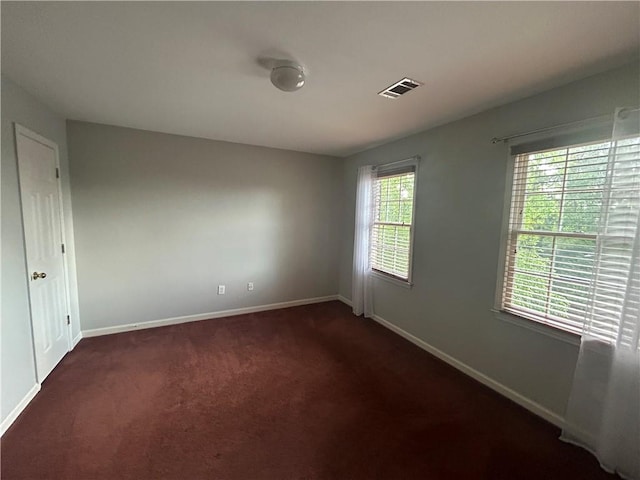 carpeted empty room featuring plenty of natural light