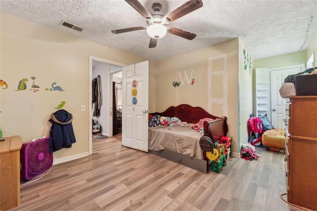 151 Grandma Branch Rd, Grantville, GA 30220 - bedroom featuring baseboards, wood finished floors, visible vents, and a textured ceiling