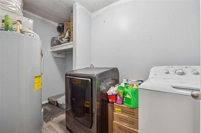 151 Grandma Branch Rd, Grantville, GA 30220 - laundry area featuring water heater, laundry area, wood finished floors, independent washer and dryer, and a textured ceiling