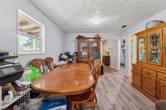 151 Grandma Branch Rd, Grantville, GA 30220 - dining area featuring a textured ceiling, visible vents, and light wood-style flooring