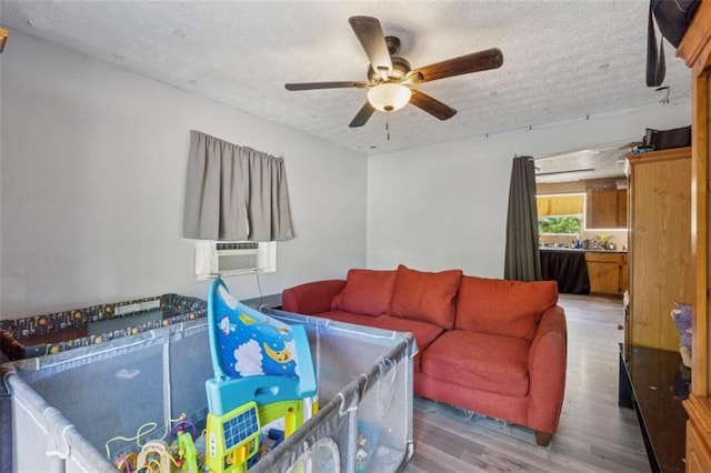 151 Grandma Branch Rd, Grantville, GA 30220 - living area featuring wood finished floors, a textured ceiling, cooling unit, and ceiling fan