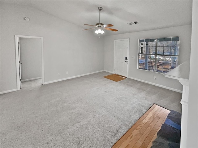 unfurnished living room with ceiling fan and carpet