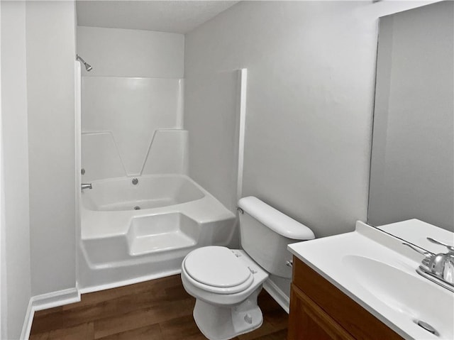 full bathroom featuring hardwood / wood-style floors, vanity,  shower combination, and toilet