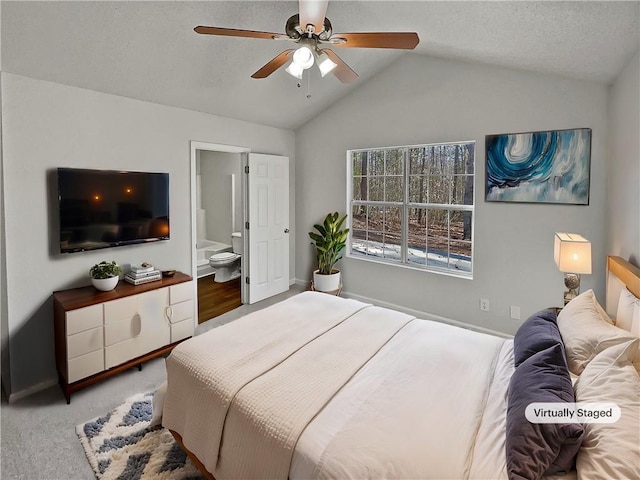 carpeted bedroom with ensuite bath, ceiling fan, and lofted ceiling